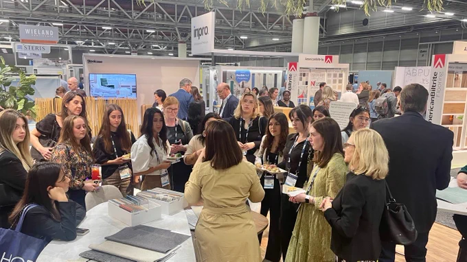 A group of attendees learning about Designtex health textiles at the Healthcare Design Conference.