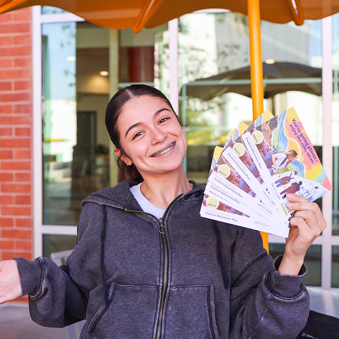 a girl smiling with the student adventure pass
