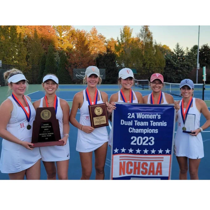 A group photo of all 6 players holding a banner that says "2A Women's Dual Team Tennis Champions 2023. NCHSAA."