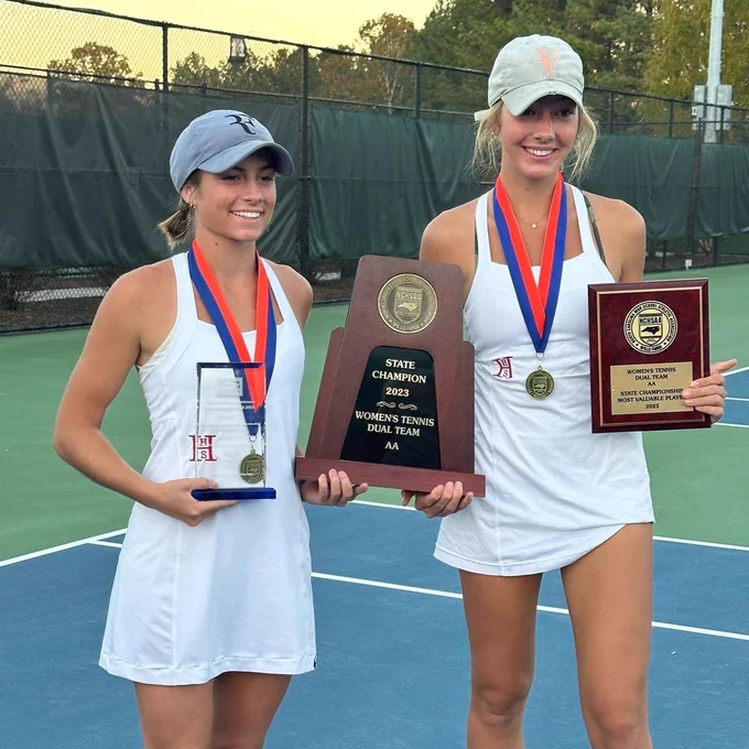 Eliza Perry and Ramsey Ross holding three awards with medals around their necks smiling at the camera.