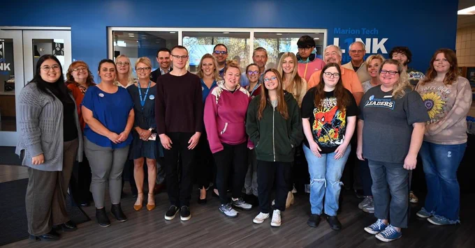 Students, faculty and staff smile.
