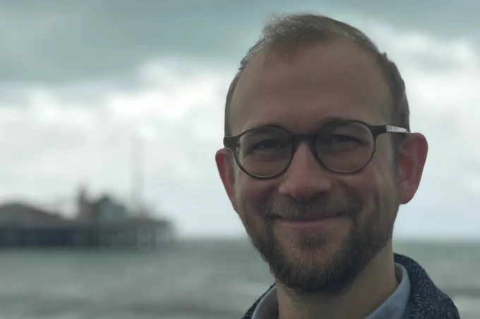 Jens Madsen in focus with Brighton pier in the background