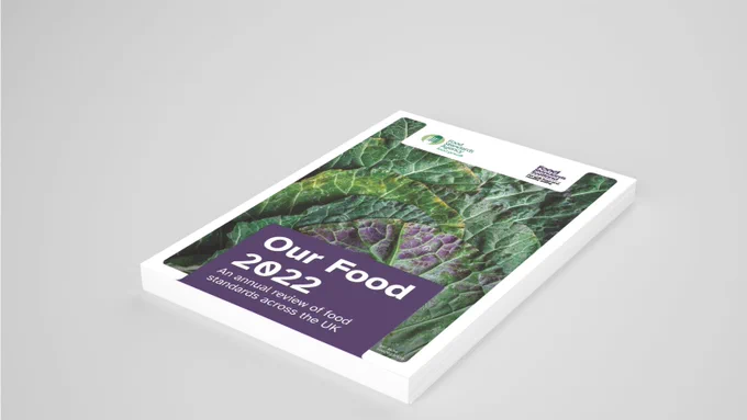 Mock-up of Our Food 2022: An annual review of food standards across the UK’ as a weighty tome on a grey background. 