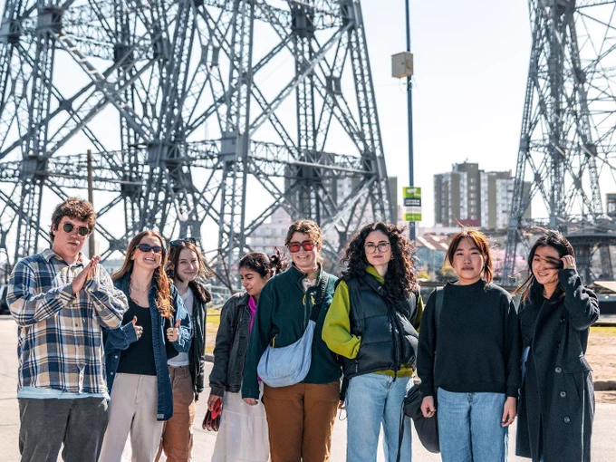 students posing near a tower in the La Boca neighborhood