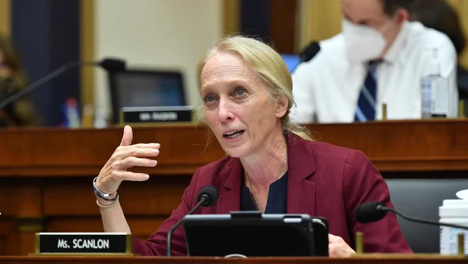 A photo of Rep. Mary Gay Scanlon speaking into a microphone at a committee meeting. 