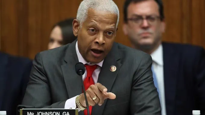 A photo of Rep. Henry Johnson speaking into a microphone. 
