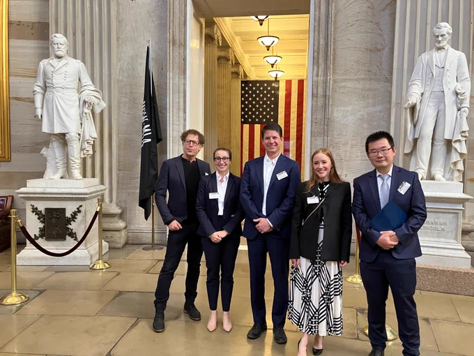 A group of five UC researchers poses for a picture in front of the American flag and statues of Ulysses S. Grant and Abraham Lincoln. From left to right: Ken Goldberg, UC Berkeley; Leilani Gilpin, UC Santa Cruz; David Danks, UC San Diego; Brandie Nonnecke, CITRIS Policy Lab; William Wang, UC Santa Barbara. 