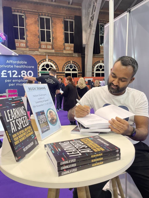 Image of Nelson Sivalingam signing copies of his book, Learning at Speed, at the Kogan Page stand