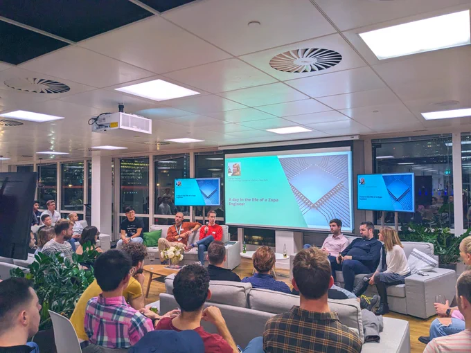 Talk on the topic of engineering from speakers in front of a screen