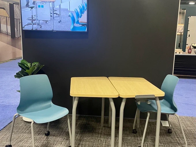Two student desks on wheels are paired with two chairs on wheels at the Steelcase Learning booth at EdSpaces.