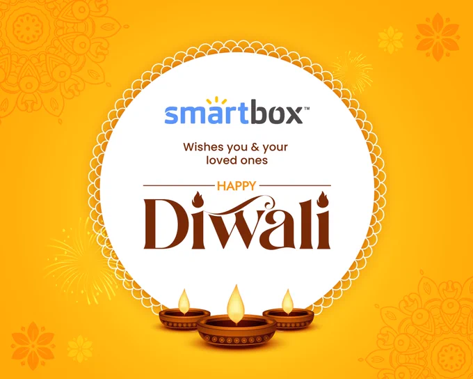Decorations of Diwali on a yellow background with a Rangoli in the middle and text 'Smartbox wishes you and your loved ones a very happy Diwali'