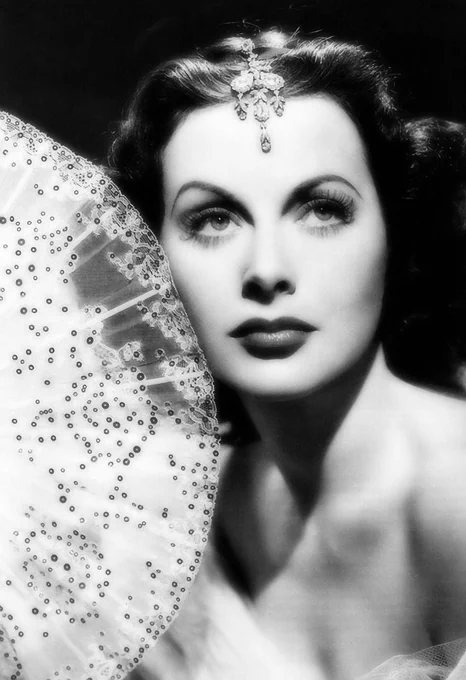 Digital art of Hedy Lamarr holding a fan by Brigitte Werner on Pixabay.