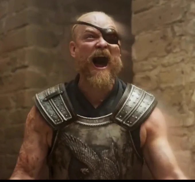 Guy Roberts as Uno Nomesta, wearing bloodied armor from all the bad guys he has been kicking the shit out of, screaming his bloody head off in delight that the strike is over!