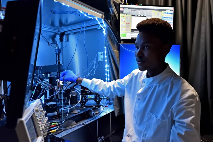 A photograph of a male researcher interacting with equipment in a Bioengineering laboratory.