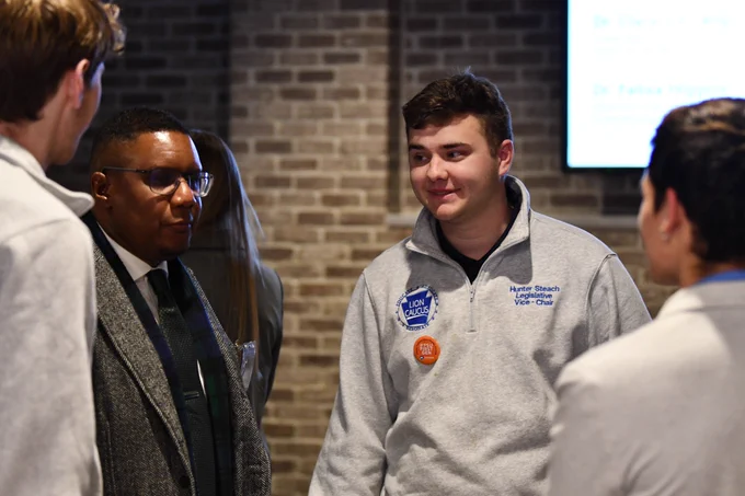Dean Clarence Lang speaking with Penn State students who are representing the Lion Caucus on campus.