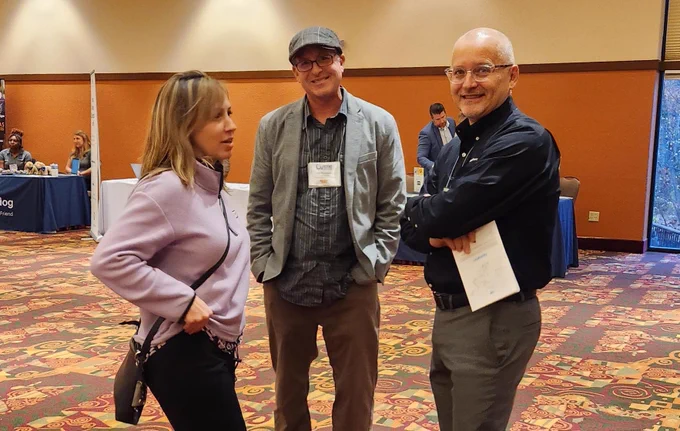 CollegeSource team member chatting with attendees at the 2023 WACRAO Annual Conference