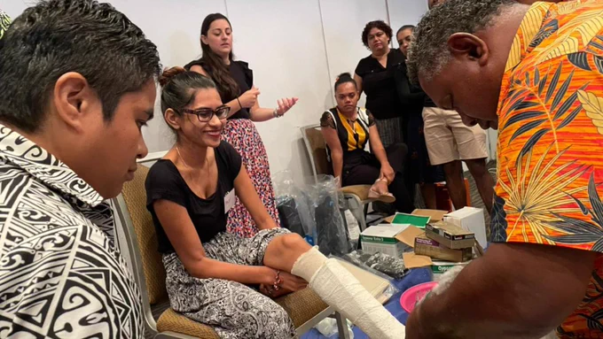 Group of Training in Assistive Product learners in Fiji. One learner is having a total contact cast.