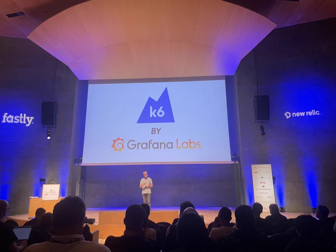 axa auditorium with slide about k6 by grafana