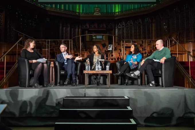 The panel sat on stage talking.
