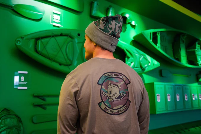 Student standing with his back to the camera wearing a shirt from the Nike Duck Veteran collection