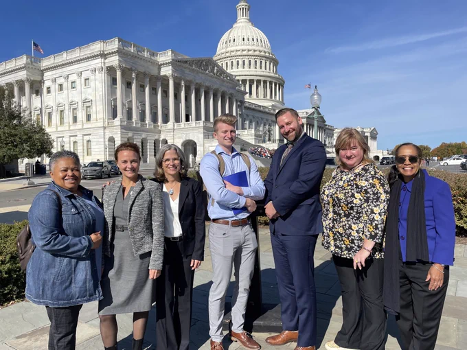 From left to right Monica Lewis Patrick with We the People of Detroit , Rebecca Esselman from HRWC, Liz Kirkwood with FLOW - For Love of Water, Hudson Villeneuve and Bentley Johnson from Michigan League of Conservation Voters, Elaine Isley with @West Michigan Environmental Action Council and Erma Leaphart from the Sierra Club Michigan Chapter stand in front of the US Capitol building in Washington DC.