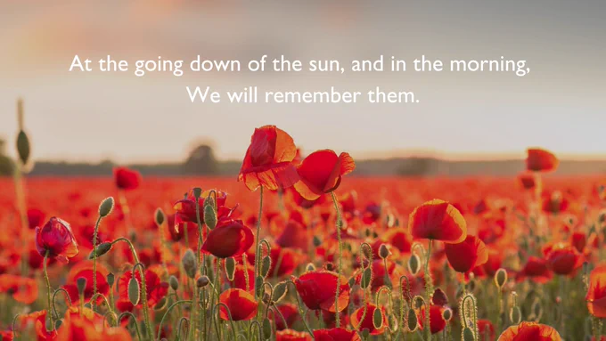 An image of a poppy growing in a field of poppies. Words in white text read "At the going down of the sun, and in the morning, we will remember them."