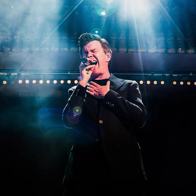 Rick Astley singing on a stage