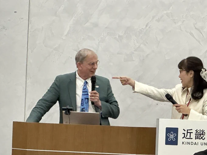 Photo of Drs. Joe Lucyshyn and Mami Mitachi speaking at a podium.