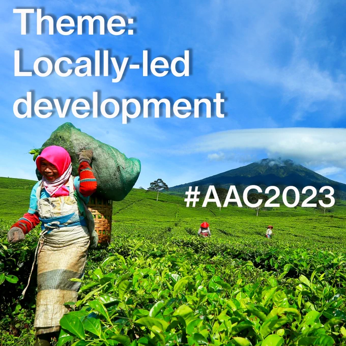 Theme: Locally-led development
#AAC2023
Woman in a field under blue sky.