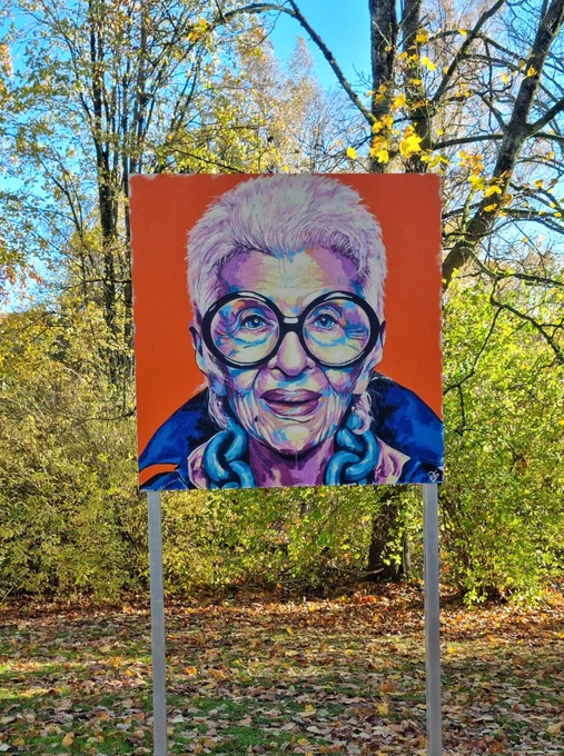 My portrait of Iris Apfel with colourful leafs in the background.