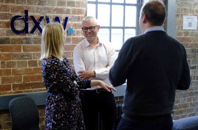 Our CEO Dave standing up chatting to a couple of folks in our Leeds HQ
