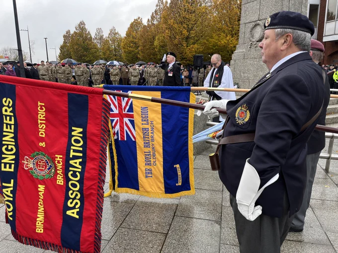 Men pay their respects with standard flags at Oldbury war memorial