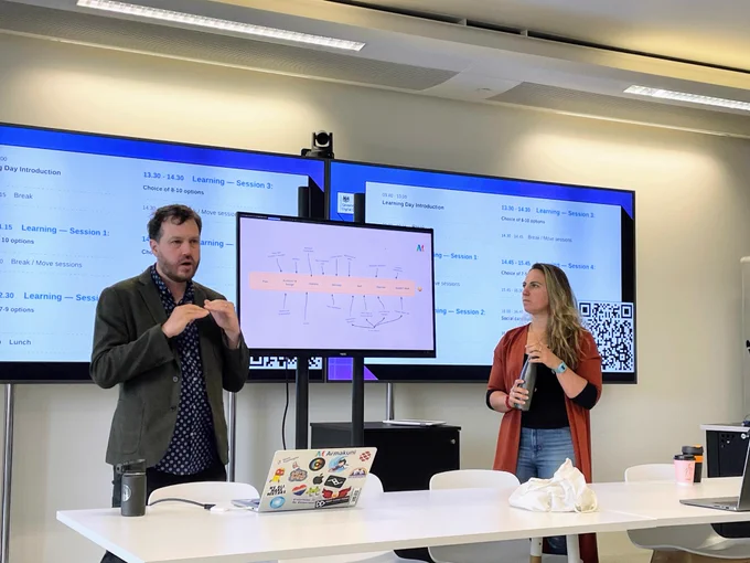 Two people presenting in GDS offices