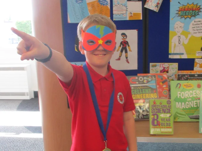 child wearing superhero mask and adopting superhero pose