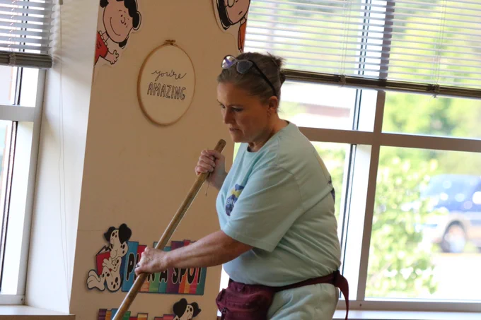 OES custodian Donna Davis cleans the floor of a classroom