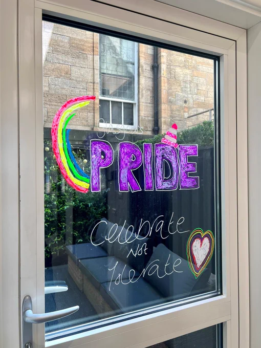 Glasgow's Pride logo is displayed on a window. 