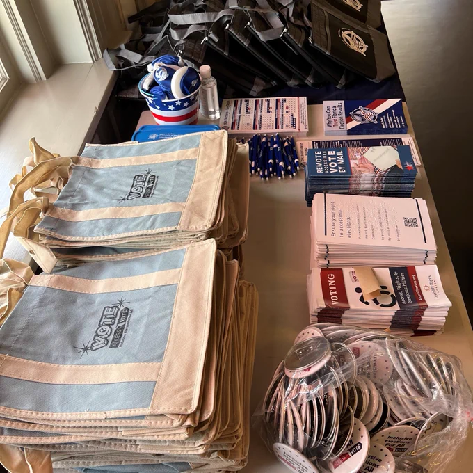Photo of table with giveaway items and educational materials provided by Access the Vote, Disability Rights Florida and Leon County Supervisor of Elections