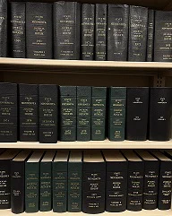 Minnesota House and Senate Journals on a library shelf.