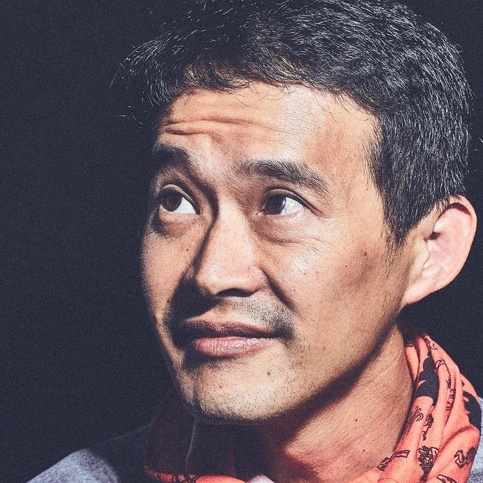 A neck-up profile picture of Robert Ling looking off to his right. He is wearing a red November Project buff around his neck. 