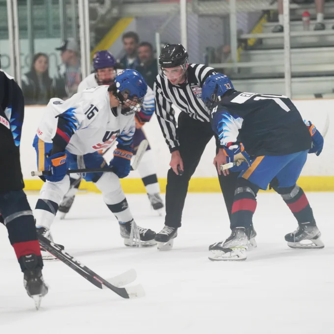 Team Blue and Team White players prepare for a face off