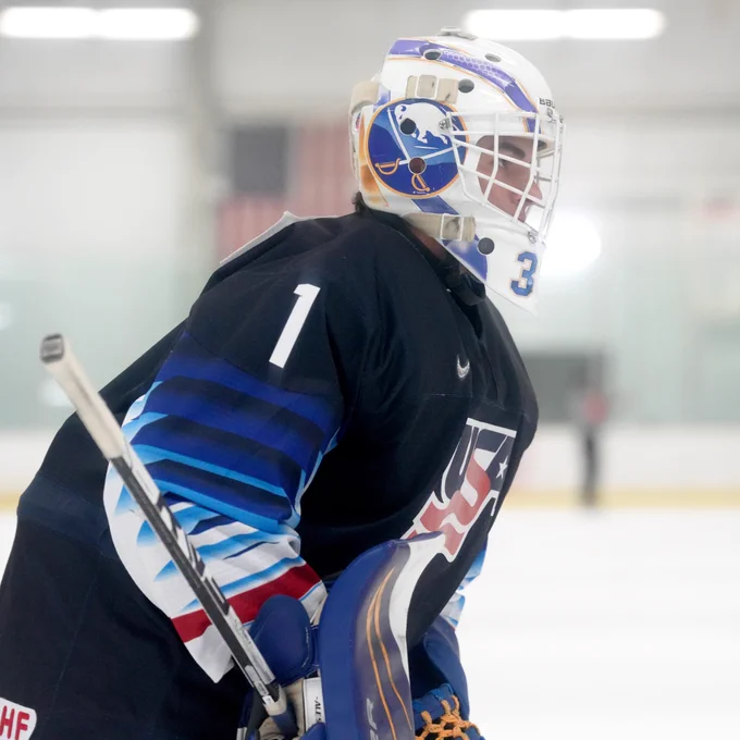 Team Blue goaltender looks on during a play on the ice