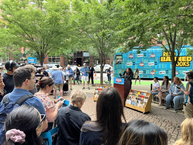 Rahna Epting speaking to a crowd in front of MoveOn's Banned Bookmobile.