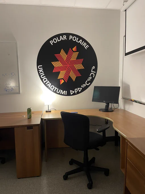 A photo of a giant, polar knowledge, Canada sticker on my  lab wall