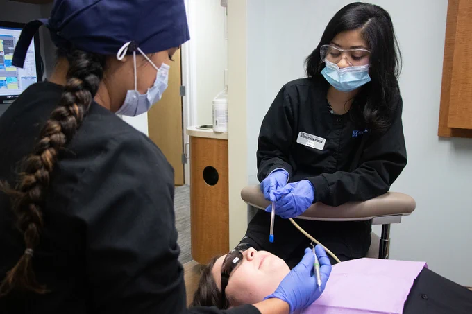 A photo of students using medical equipment. 
