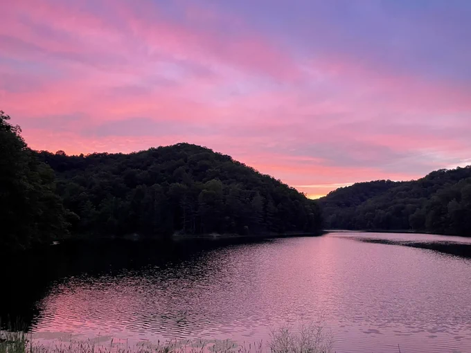 Sunset sky over a lake and small mountains