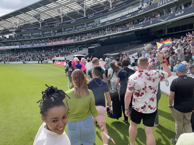 Guests at the Oval wave Pride flags as they head around the ground on a walkabout