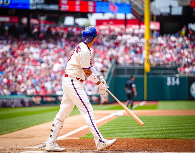 Photo of Nick Castellanos preparing to run after hitting a home run.  He is wearing the white Phillies uniform with a blue and red helmet.