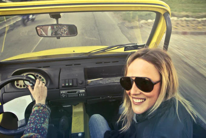 Woman In Black Aviator Sunglasses Sitting On Car's Passenger Seat