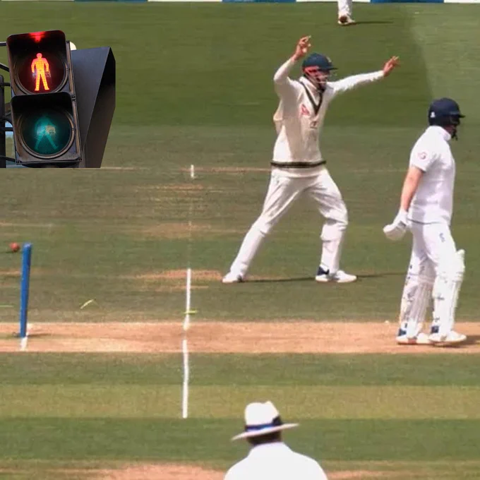 Camera shot of Jonny Bairstow stumped during an Ashes cricket test match. Image of red pedestrian traffic light has been digitally imposed.