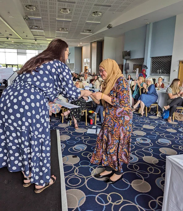 Nazma collecting her certificate